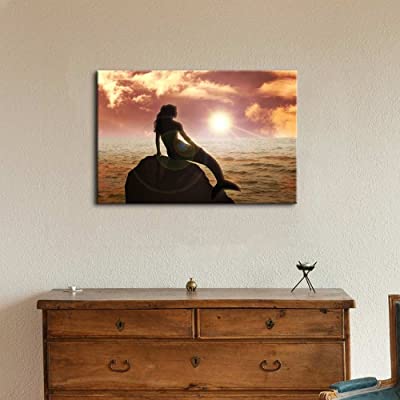 canvas art of a mermaid on a rock