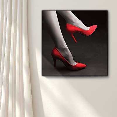 a canvas art featuring a womans legs with red high heels on her feet mounted on a white wall next to curtains