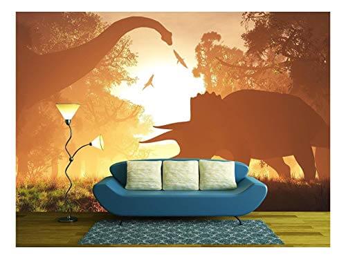 wall mural featuring the silhouettes of dinosaurs behind a couch