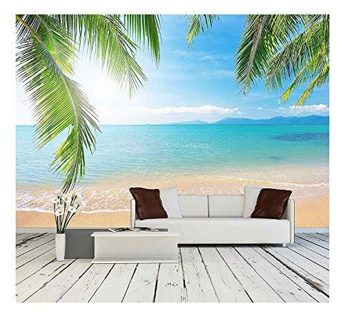 wall mural of a tropical beach behind a couch and wooden floor