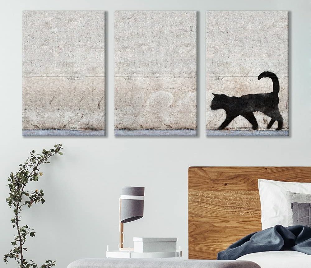 example of a cat themed gift canvas featuring a black cat on the wall above a couch