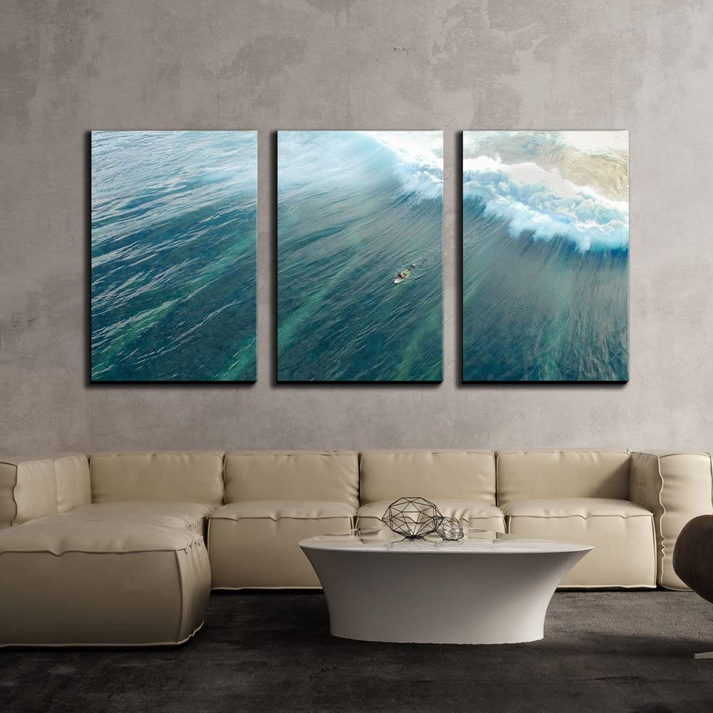 a picture wal art of the sea with a huge wave making a large boat look small ocean decor ideas