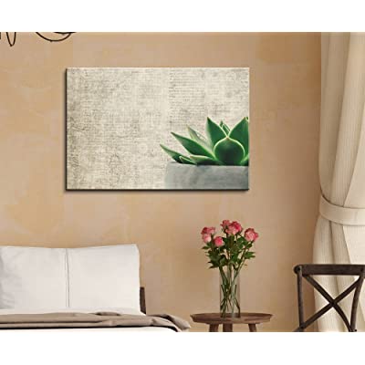 nice low key succulent sticking out of pot in canvas art on bedroom wall