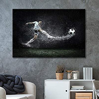 a pice of canvas art showing a soccer player kicking a ball in the rain in a bedroom