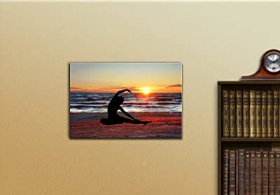 art featuring the silhouette of a woman doing yoga on the beach